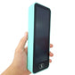 Mint green LCD writing tablet screen held in hand showing display