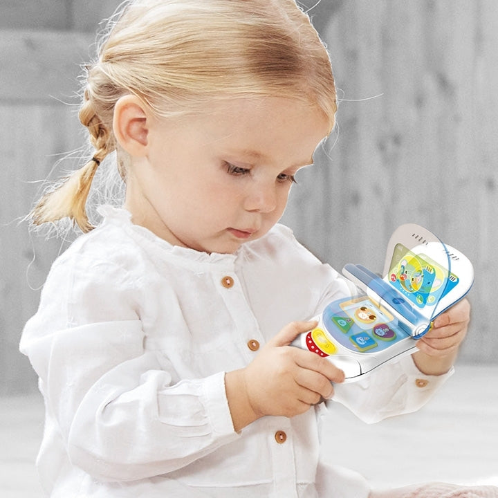 Toddler playing with flip up sounds phone toy
